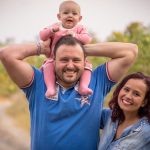 A cheerful family of three, enjoying a day outdoors. Perfect for family, happiness, and togetherness concepts.